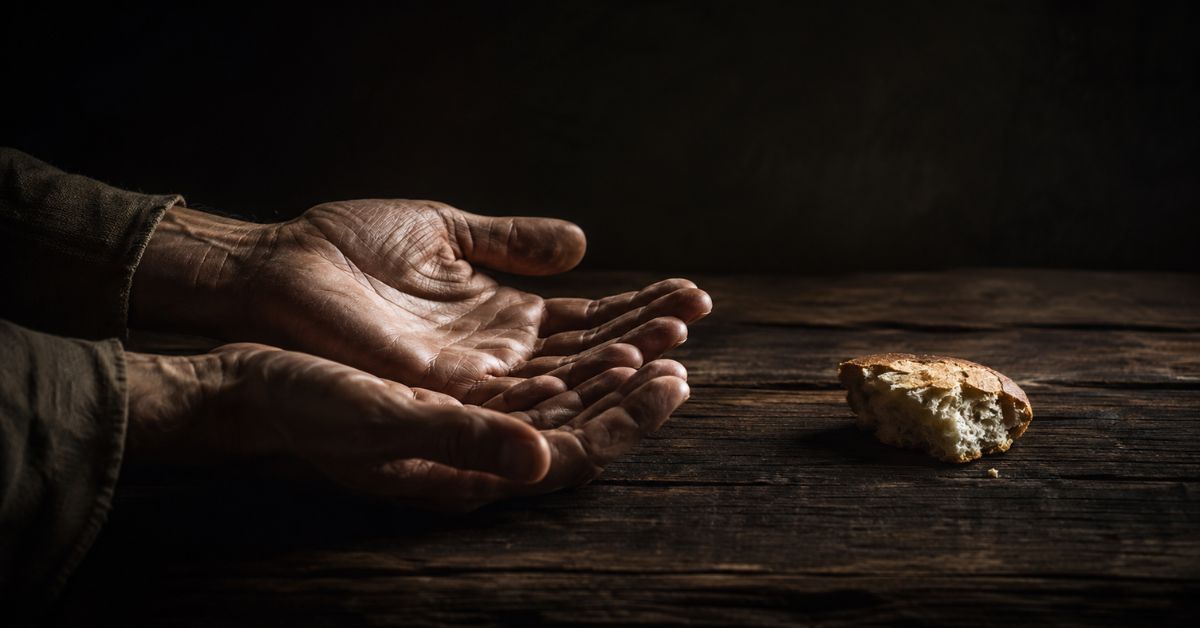 hands grasping for bread as a symbol for spiritual pride and spiritual humility